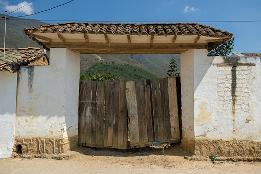 An old and rickety wood plank gate, in the colonial town of Villa de Leyva, in central Colombia.