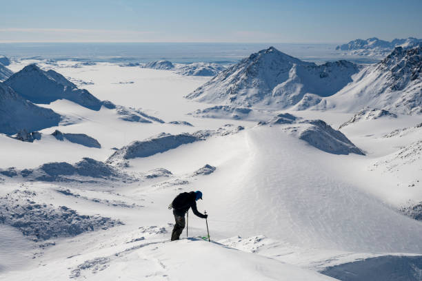 istock Ski mountaineer prepares to descend slope 2107409163