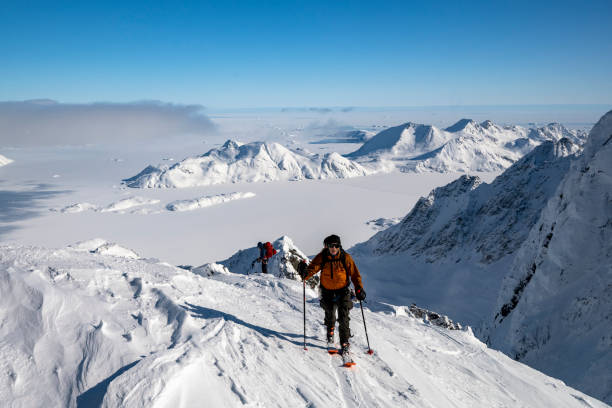 istock Ski mountaineer ascends snowcapped mountain 2107409164