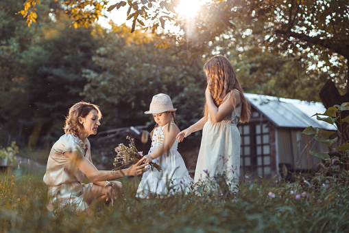 Mother and daughters enjoying a sunny weather in nature