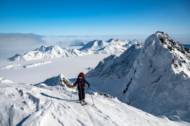 istock Ski mountaineer ascends snowcapped mountain 2107412841