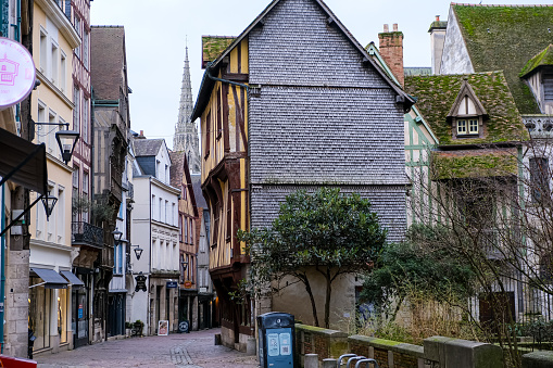 Rouen, France - 19.02.2024. Rue Saint Romain street by the Notre-Dame cathedral in old historic part of Rouen, Normandy, France. Old houses in the tourist center of Rouen, built in the traditional Normandy style.