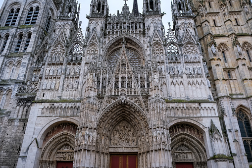 Rouen, France - 19.02.2024. Rouen Cathedral (Cathedrale de Notre-Dame) in Rouen, capital of Haute-Normandie, France. The facade of the Gothic church building, it is famous for its three towers, each in a different style.