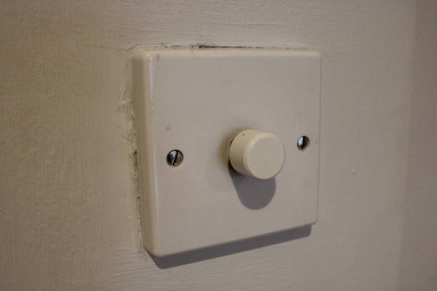 istock White dimmer switch white wall background, taken indoors 2107457955