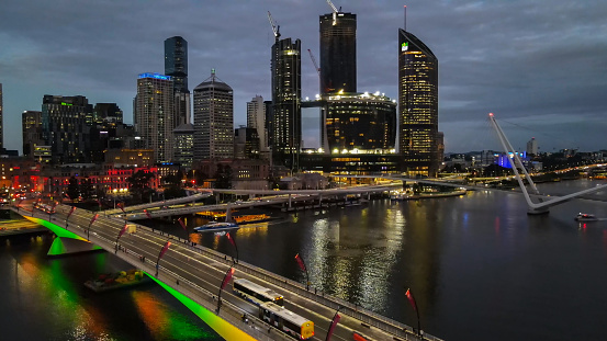 Low aerial drone view of Brisbane central business district, QLD, Australia along Brisbane River during dusk evening in March 2024