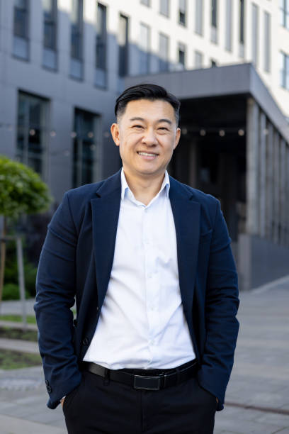 istock Confident businessman smiling at camera in urban setting, professional attire 2107473738