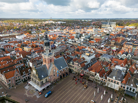 Aerial view of the Waag in Alkmaar with the historic city center in the background on a cloudy day