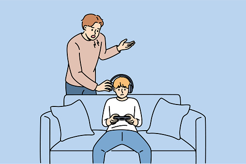Father yells at naughty child who plays video games and refuses to do homework or comply with parents demands. Naughty guy resists upbringing, wanting to become cyber athlete or professional gamer