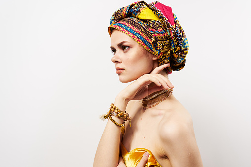 pretty oriental woman multicolored turban jewelry bare shoulders luxury. High quality photo
