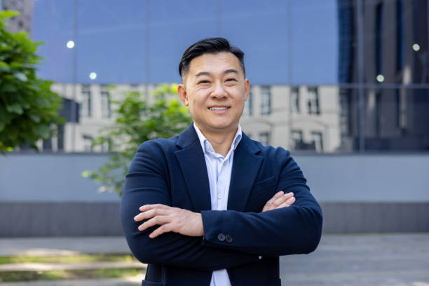 istock Confident businessman standing in front of office building 2107557195