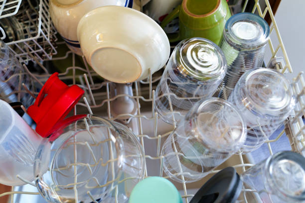 Clean Dishes Detail in Dishwasher Rack - Glasses, bowls and other clean dishes with selective focus and vivid colors and soft focus background.