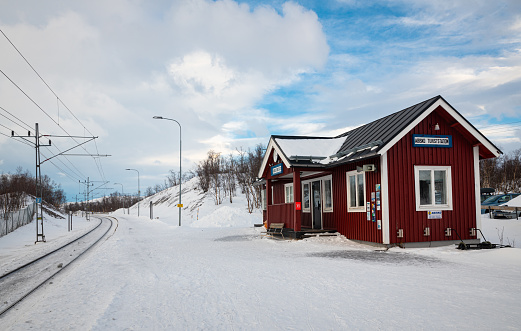 Abisko, Sweden - February 24, 2024: Red colored train station of Abisko Östra near visitors center in Abisko National Park, northern Sweden.