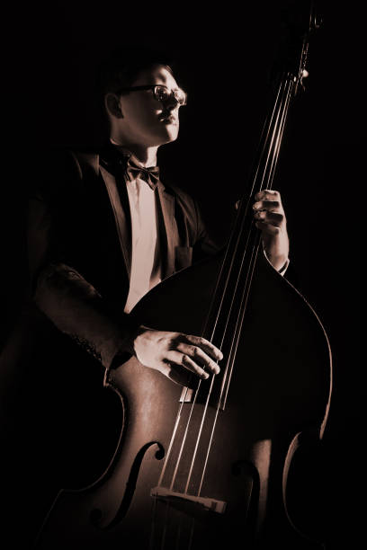 istock Double bass player playing contrabass pizzicato 2107575255