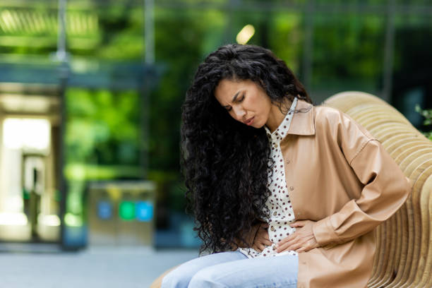 istock Young hispanic businesswoman taking a break outside office building with greenery 2107576812
