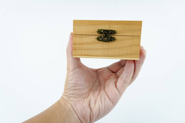 istock hand holding small wooden box on white background. 2107581553
