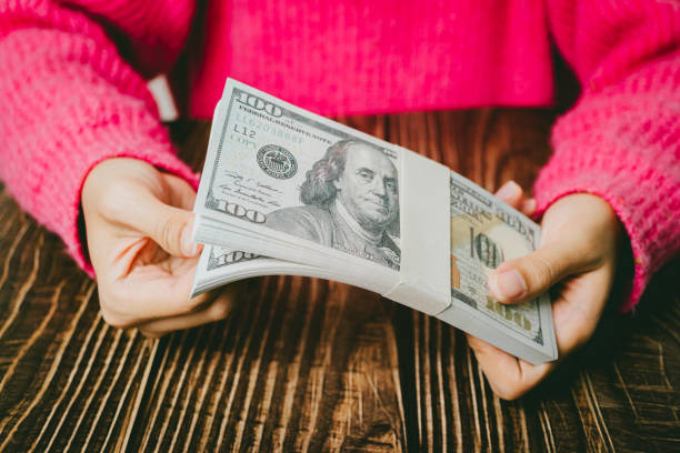 istock Female hands holding banknotes, finance concept 2107582064