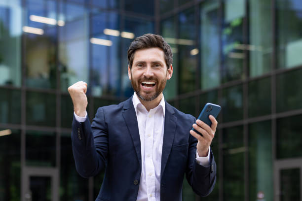 istock Enthusiastic professional celebrating success outside modern office building 2107597681