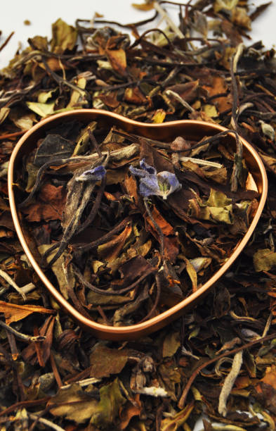 istock Heart with lavender and lemon balm tea leaves 2107623639