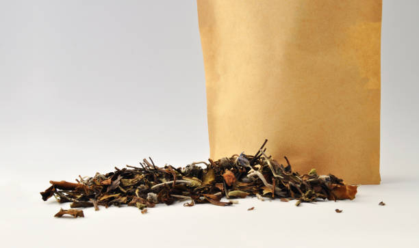 istock Artisanal lavender and lemon balm tea leaves outside the package that contains it 2107623640