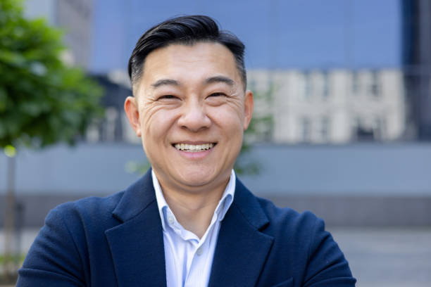 istock Confident businessman smiling outdoors with urban background in high-resolution portrait 2107648155