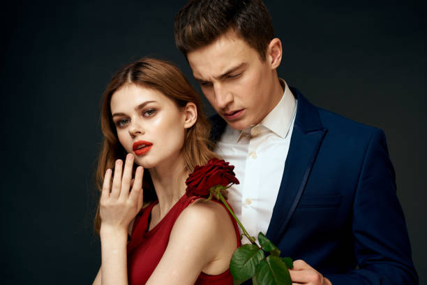 istock luxury couple hug romance relationship rose over dark isolated background 2107664917