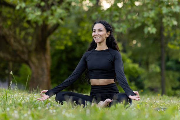 istock Woman practicing yoga in a tranquil park setting 2107671784