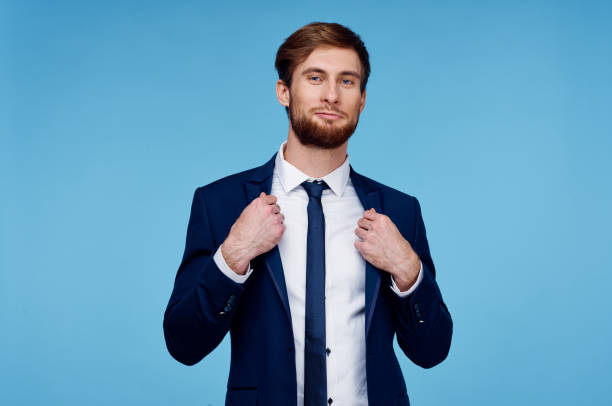 istock handsome man in suit self-confidence official blue background 2107703215