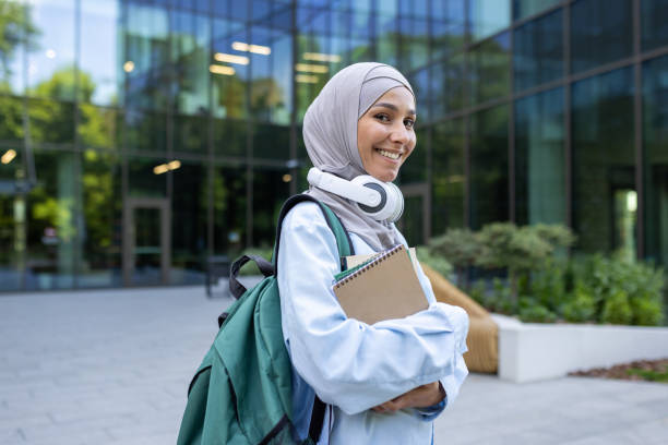 istock Modern student with headphones and backpack in urban setting 2107781088