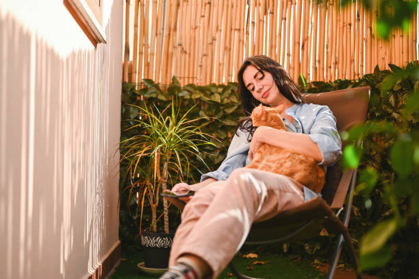 istock Cheerful woman relaxing at home with cat. 2107837655