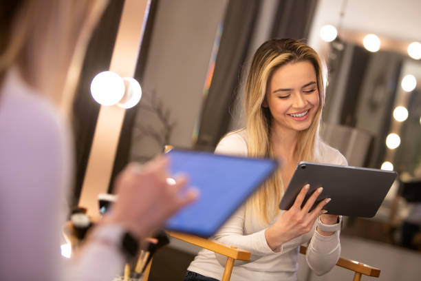 istock Creative Connectivity: Smiling Young Blonde Woman Sketching on Tablet in Modern Setting 2107904836