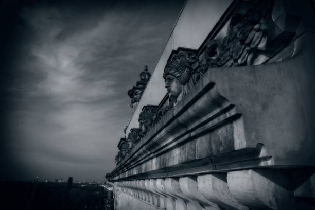 istock Dramatic black and white image of architectural details with sculptures on a historic building facade. 2107947439