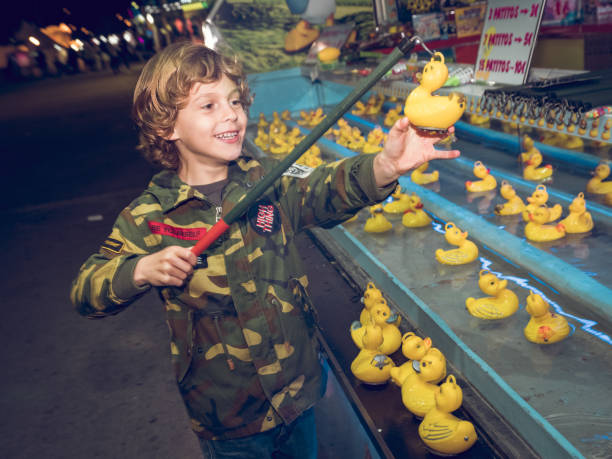 Kid catching rubber duck in amusement park