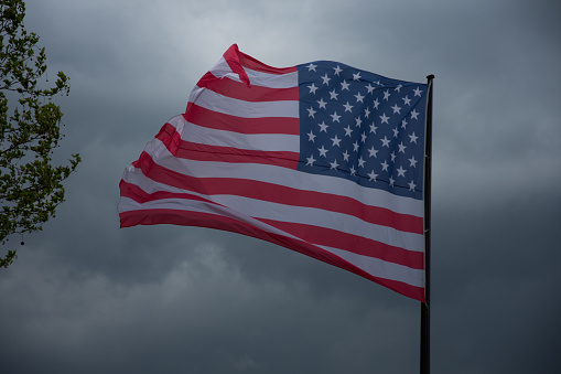american flag on a cloudy sky