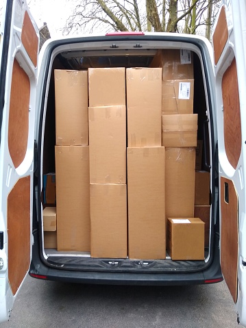 delivery van loaded to the roof | rear door open showing the amount of goods loaded