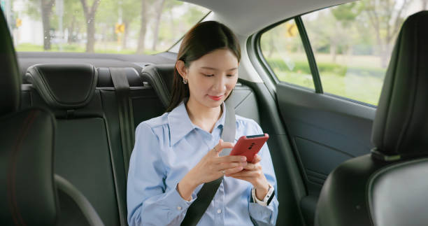 istock woman sit taxi use mobile 2108119835