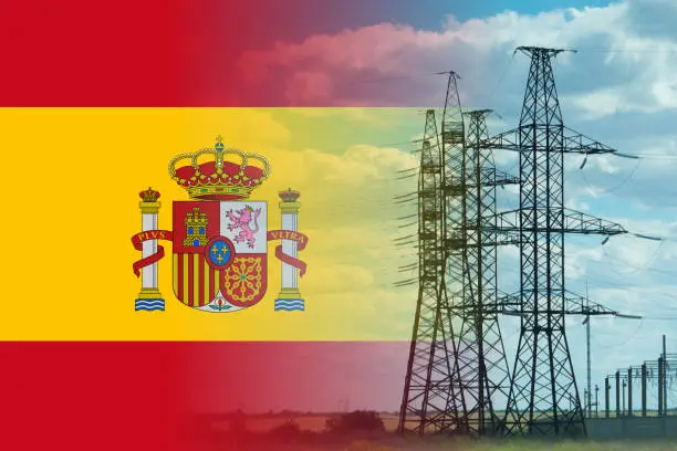 Spain flag and electricity pylon mixed image. Expensive electricity concept. High costs for energy.