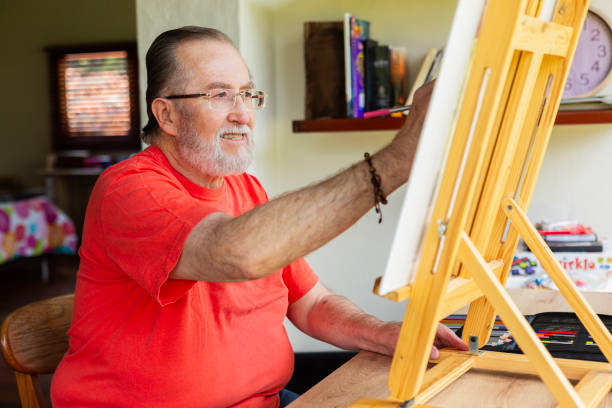 adult over 60 years old drawing in his room
