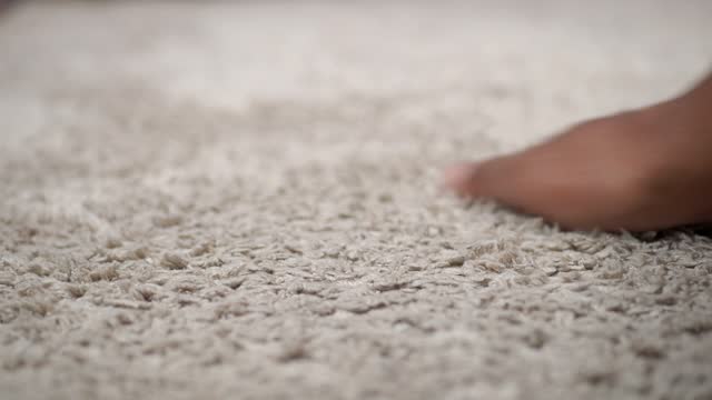 hand touching new home carpet