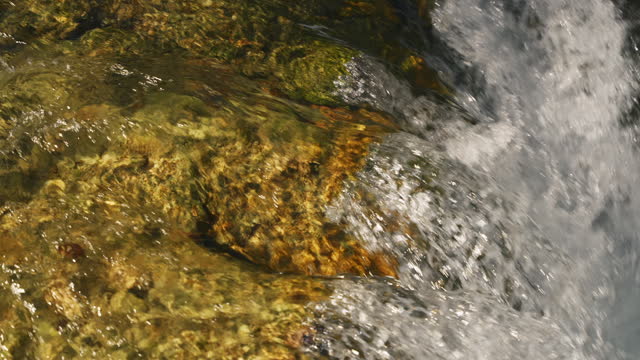 SLO MO Closeup of Freshwater River Flowing over Rocks in Forest at Plitvice Lakes National Park