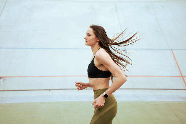 istock Athletic girl run an training in stadium. 2108521491