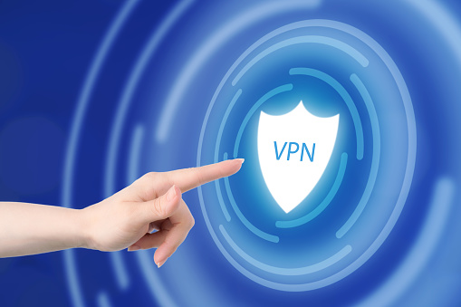 hand turns on VPN button, shield icon, data protection, secure internet access,online security.