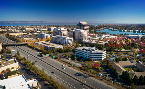 Aerial of Foster City, California with neighborhoods, a lake, San Francisco Bay, and the Diablo Range mountains in the background.  Foster City is part of the San Francisco Bay Area along the San Francisco Peninsula.