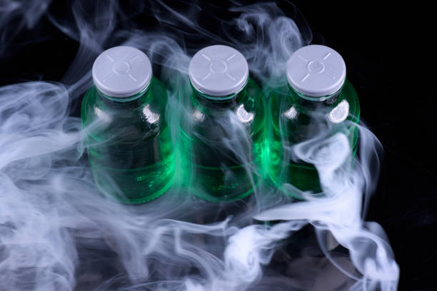 istock Medical medicine bottles with green liquid with syringe friendly plastic cap 2108619424
