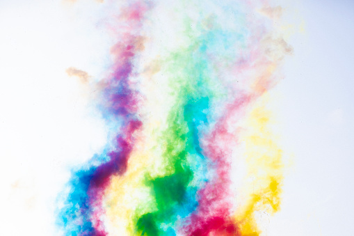 A close-up mockup of a white t-shirt with colorful Holi powder surrounding it.