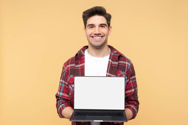 istock Smiling, handsome man displaying a laptop with a blank screen suitable for a website template 2108621597