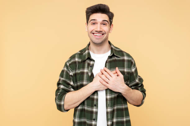 istock Cheerful man making a heartfelt gesture to express gratitude and thankfulness 2108621739