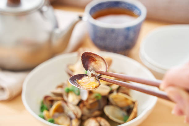 A bowl of fresh steamed clams with fresh basil and red pepper flakes