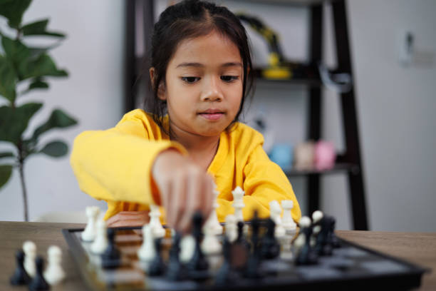 istock A young girl is playing a game of chess 2108678668