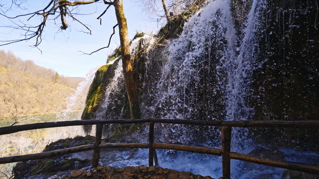 SLO MO Beautiful Waterfall on Mountain River with White Foamy Water Falling Down from Rocky Cliff in Plitvice Lakes National Park