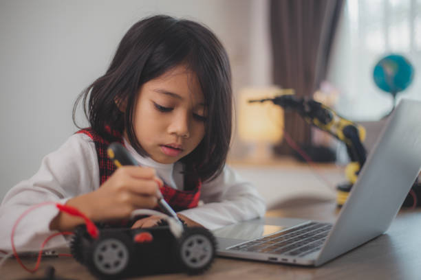 istock STEM education concept. Asian students learn at home by coding robot arms in STEM, mathematics engineering science technology computer code in robotics for kids' concepts. 2108734122